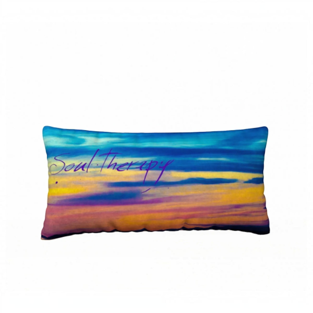 A rectangular lumbar pillow featuring an abstract sunset design with blue, purple, yellow, and orange hues, and the words 'Soul Therapy' written in purple script across the center.