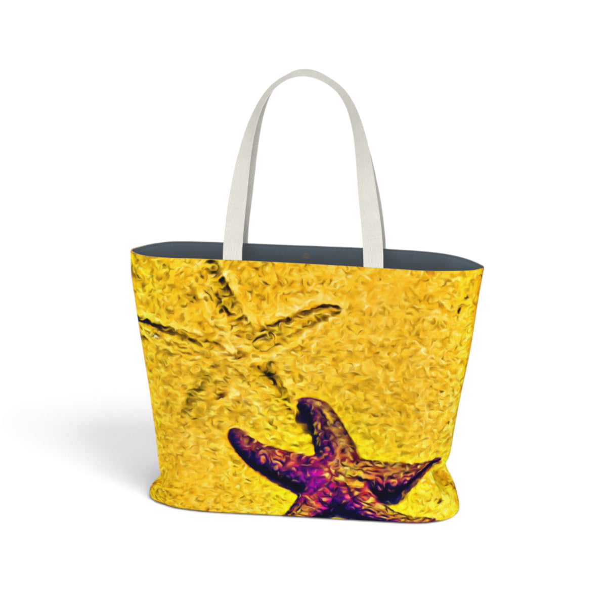 A tote bag with a textured yellow and orange starfish print, featuring white shoulder straps and a dark navy blue interior, shown on a plain white background.