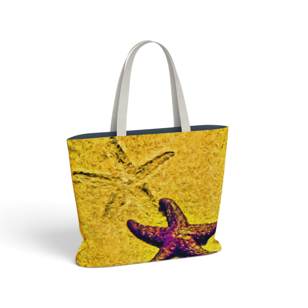 A tote bag with a textured yellow and orange starfish print and a purple starfish near the bottom, featuring white shoulder straps, shown on a white background.