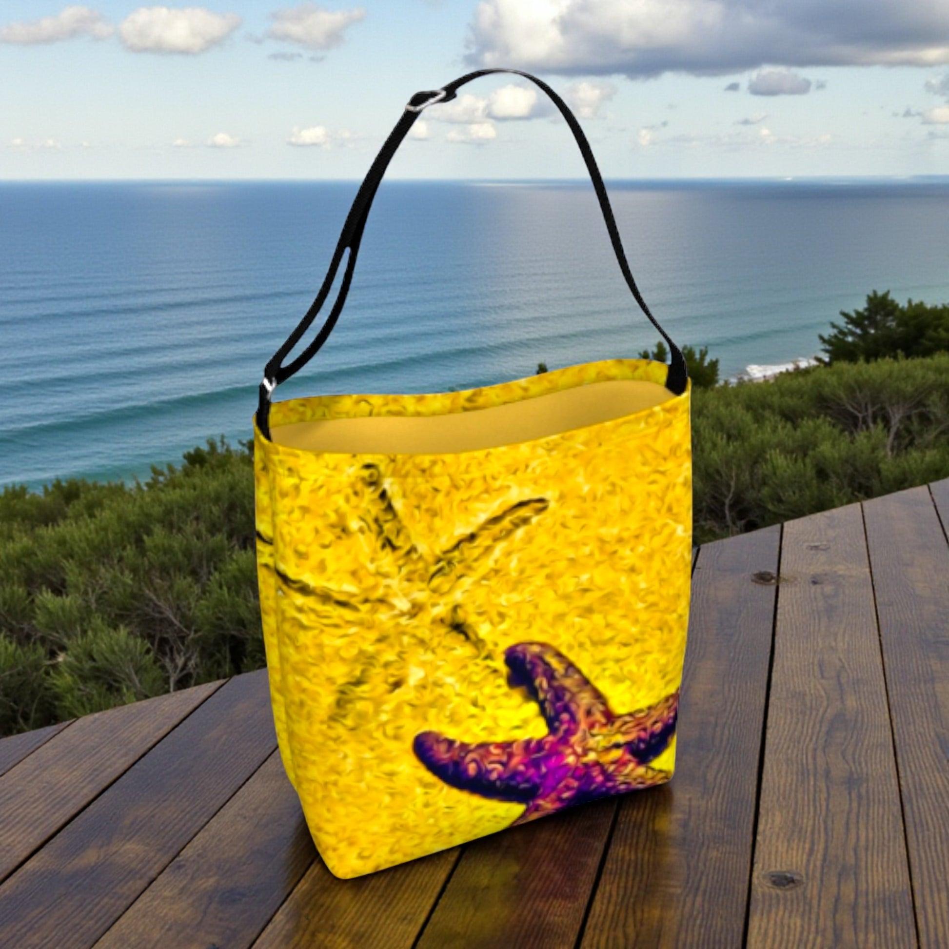Yellow bag with a starfish design on a wooden table by the ocean