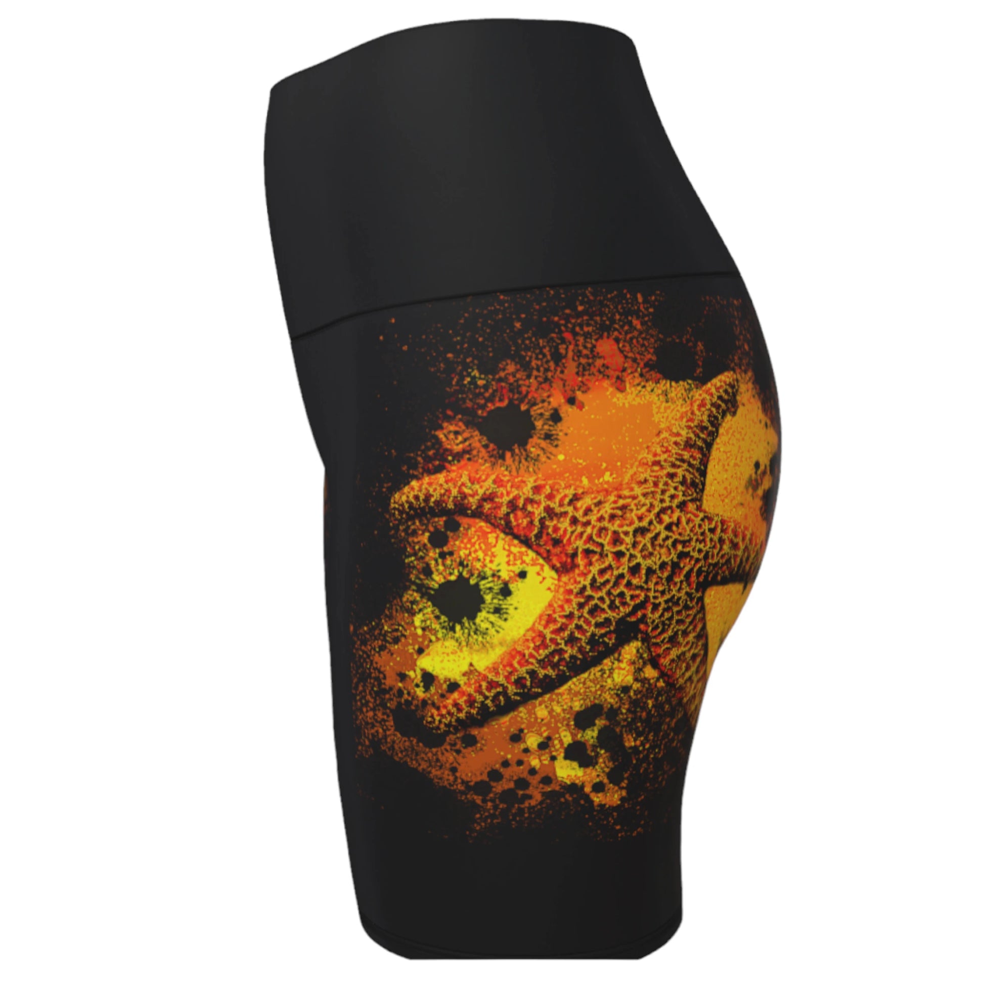 Starfish Orange Yoga Shorts features a orange starfish on a bed of abstract sand on black shorts.