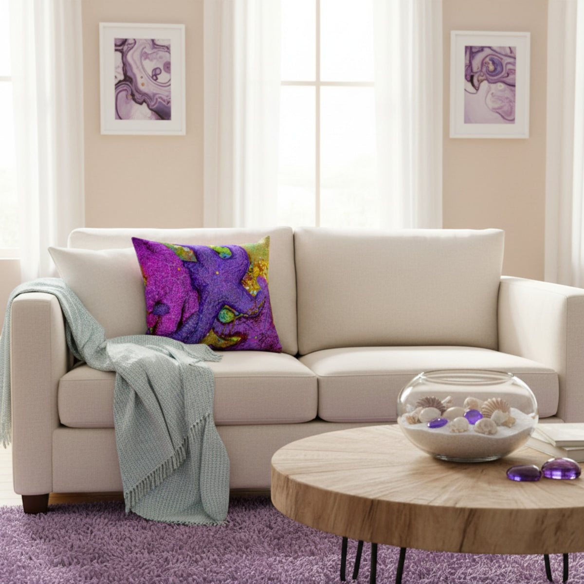 A cream-colored fabric sofa in a bright living room setting, styled with a vibrant purple and magenta abstract patterned throw pillow and a light blue-green fringed throw blanket. In front of the sofa is a round wooden coffee table with a glass bowl of seashells, and the floor is covered in a purple shag rug.
