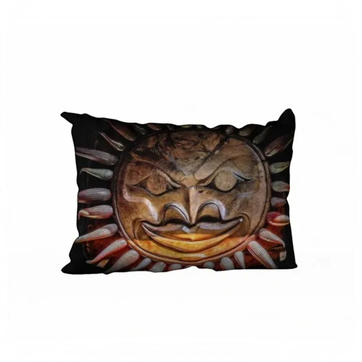 A rectangular throw pillow featuring a printed graphic of a carved wooden sun face with a wide grin and radiating rays, set against a plain white background.