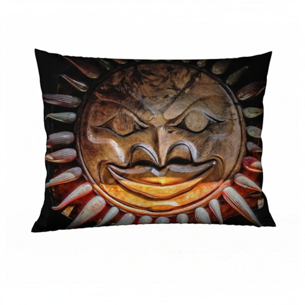 A rectangular decorative pillow featuring a printed graphic of a carved wooden sun face with a wide grin and radiating sunburst rays on a black background.