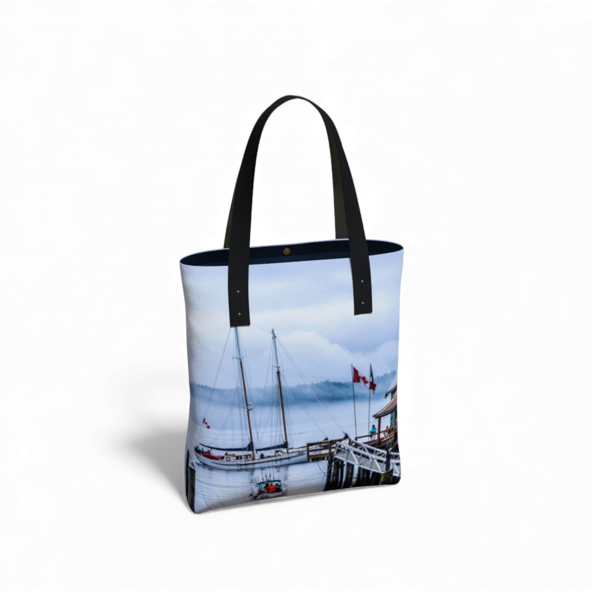 Tote bag with a scenic design of boats and a dock on a white background