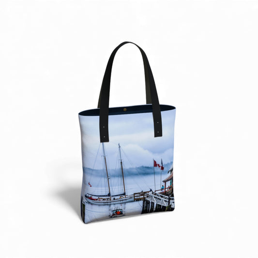 Tote bag with a scenic design of boats and a dock on a white background
