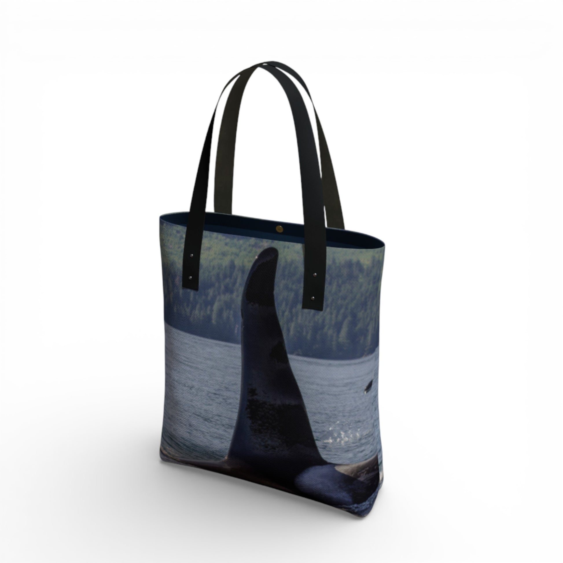 Tote bag with a design of a whale and ocean on a white background