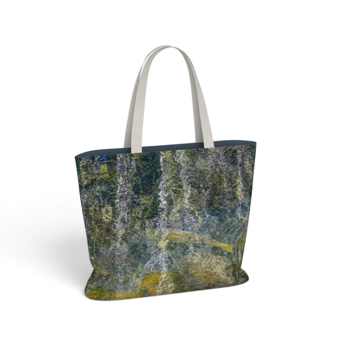 A tote bag featuring an abstract, textured print resembling tree bark in shades of green, gray, and yellow, with contrasting light gray handles, shown on a plain white background.