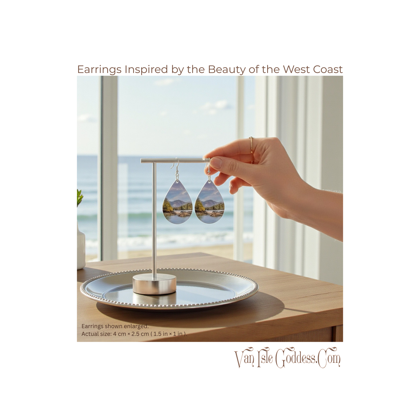 Earrings inspired by the West Coast held by a hand with a scenic background