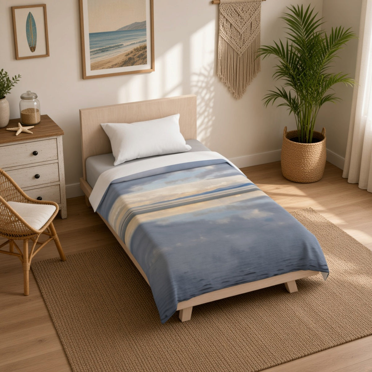 A single bed dressed in a blue and beige striped blanket, styled in a bright, modern bedroom with a wooden floor, rattan chair, and potted palm.