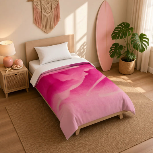 A single bed in a styled bedroom setting, featuring a vibrant pink watercolor-patterned duvet cover. The room includes a wooden headboard, a woven rug, a bedside table with a lamp and decorative shells, a potted monstera plant, and a pink surfboard leaning against the wall.