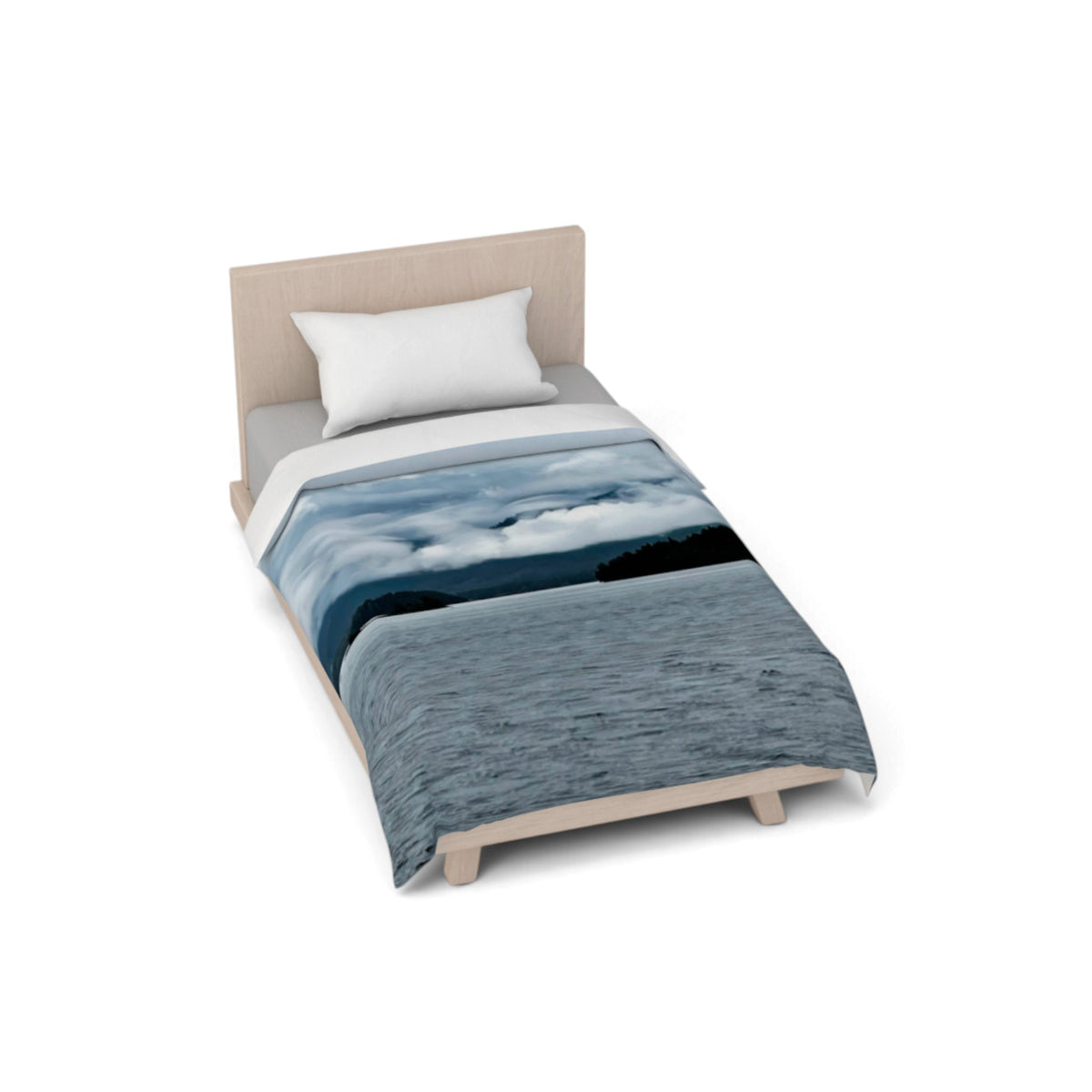 A single bed with a light wood frame and upholstered headboard, styled with a blue and white landscape print duvet cover and a white pillow, shown on a plain white background.