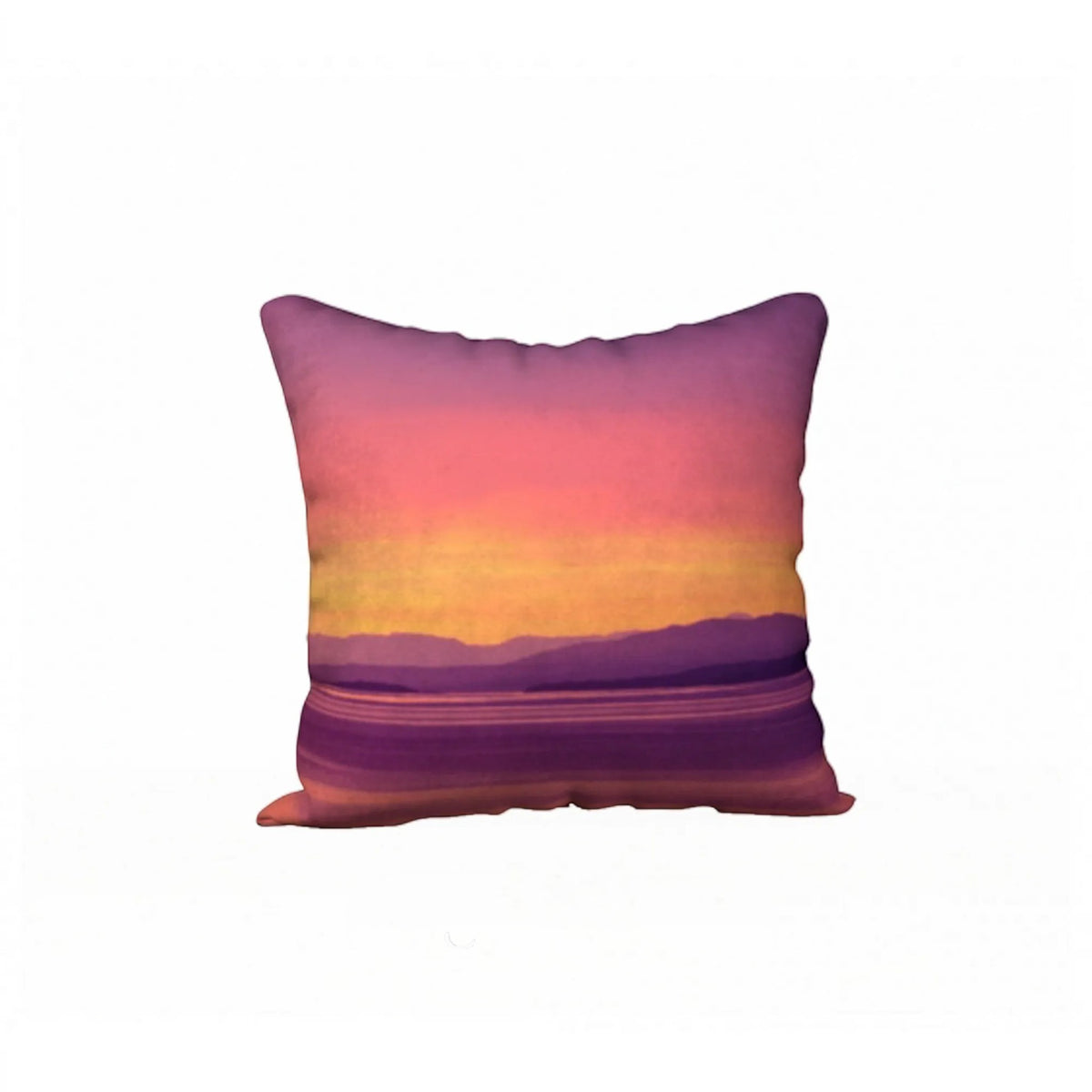 A square throw pillow featuring a printed sunset landscape design with purple, pink, orange, and yellow hues, shown against a plain white background.
