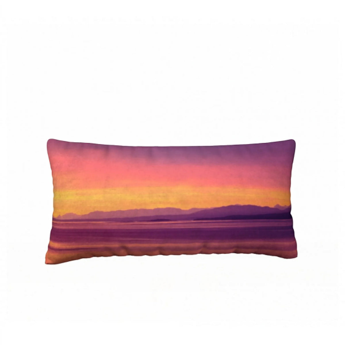A rectangular lumbar pillow featuring a scenic sunset landscape print with purple mountains, a yellow and orange horizon, and a pink-to-purple sky, shown against a plain white background.