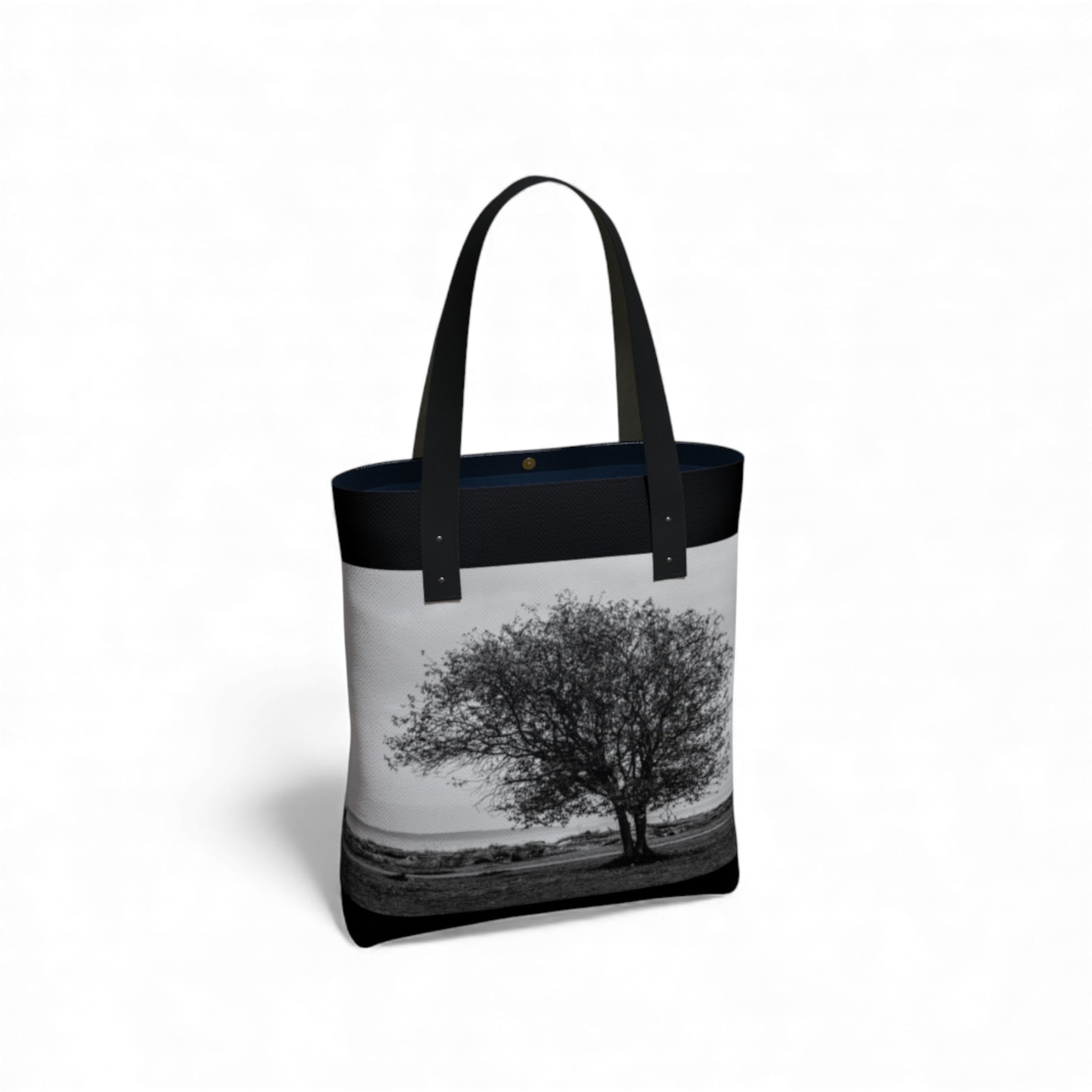 Tote bag with a black and white tree design on a white background