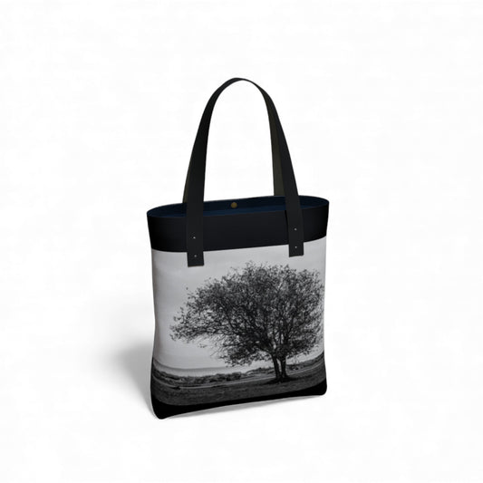 Tote bag with a black and white tree design on a white background