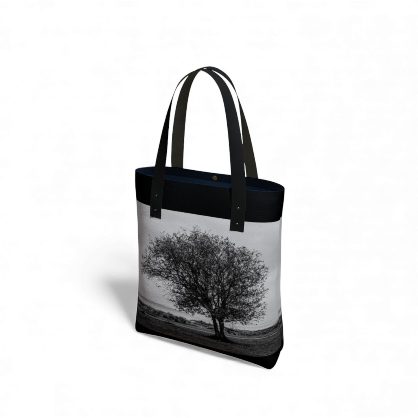 Tote bag with a black and white tree design on a white background