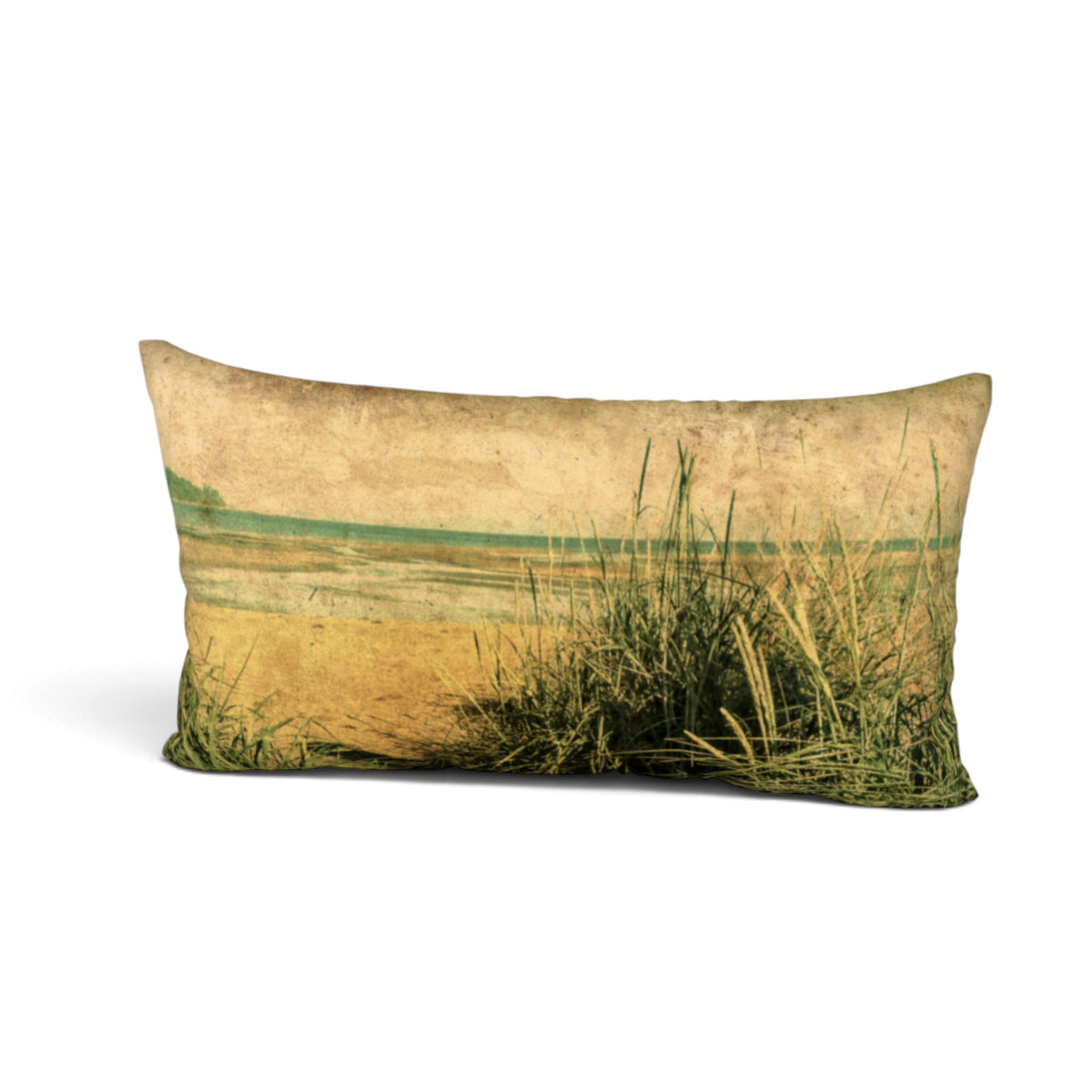 A rectangular lumbar throw pillow featuring a vintage-style landscape print of a beach or marsh with tall green grasses in the foreground and a muted green horizon under a warm beige sky.