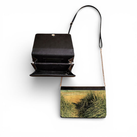 Handbag with a scenic print of a field on a white background