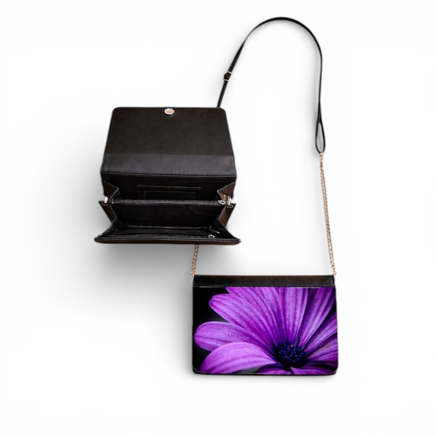 Black handbag with a purple flower design on a white background