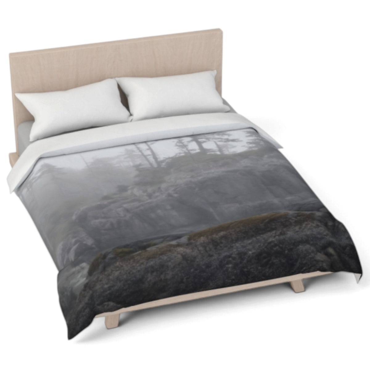 A bed dressed in a duvet cover featuring a moody, misty forest scene in grayscale, styled with two white pillows and a light wood headboard on a white background.