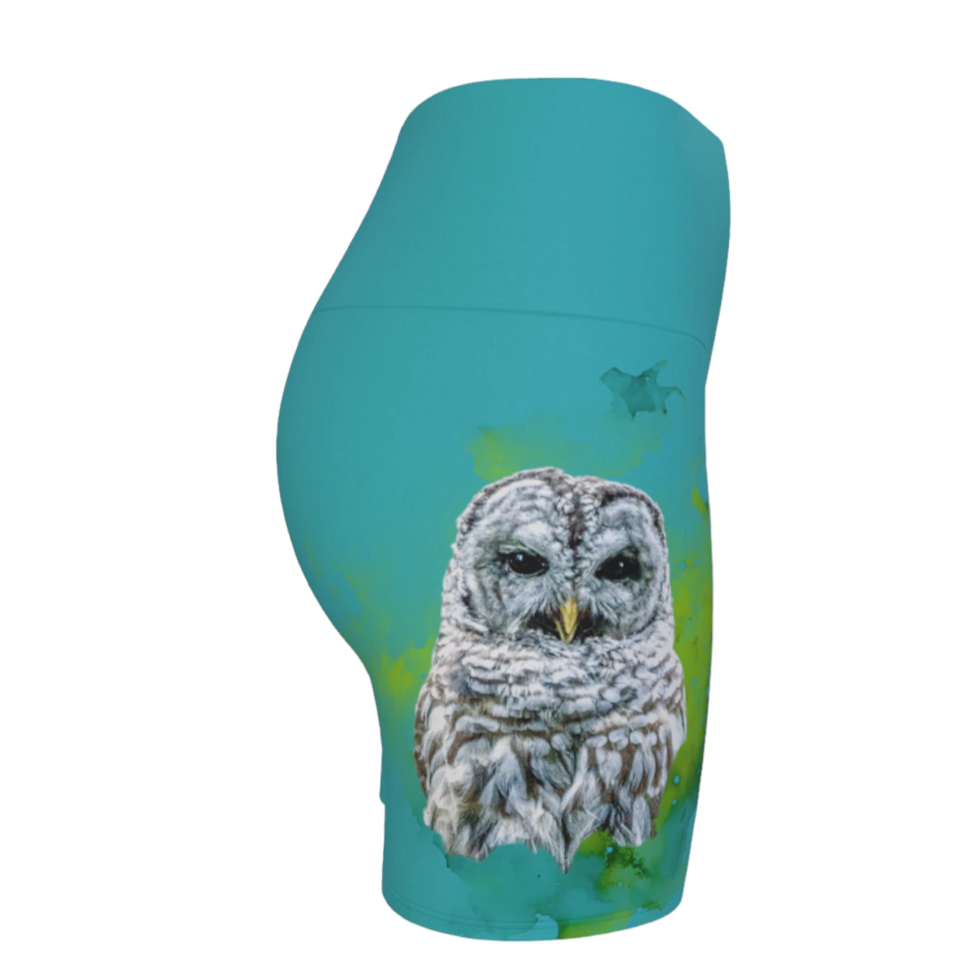 Wise owl yoga shorts features a barred owl printed on the shorts.  The rest of the shorts is turquoise in colour.