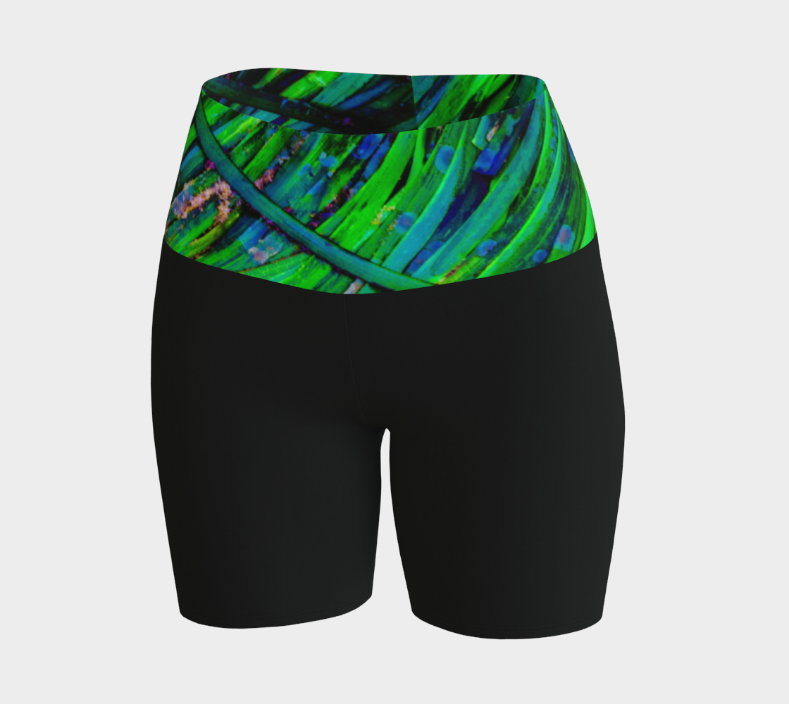 Shades of green yoga shorts features the image of spring green ocean sea grass at low tide. the rest of the shorts are black.