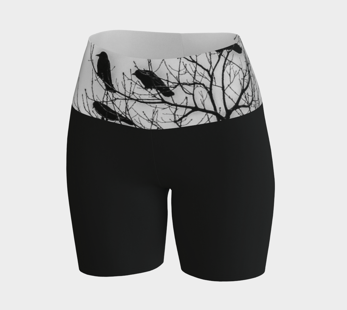 Crows Yoga Shorts feature a photograph of crows sitting in a tree printed on the band of the yoga shorts. The bottom of the yoga shorts are black.