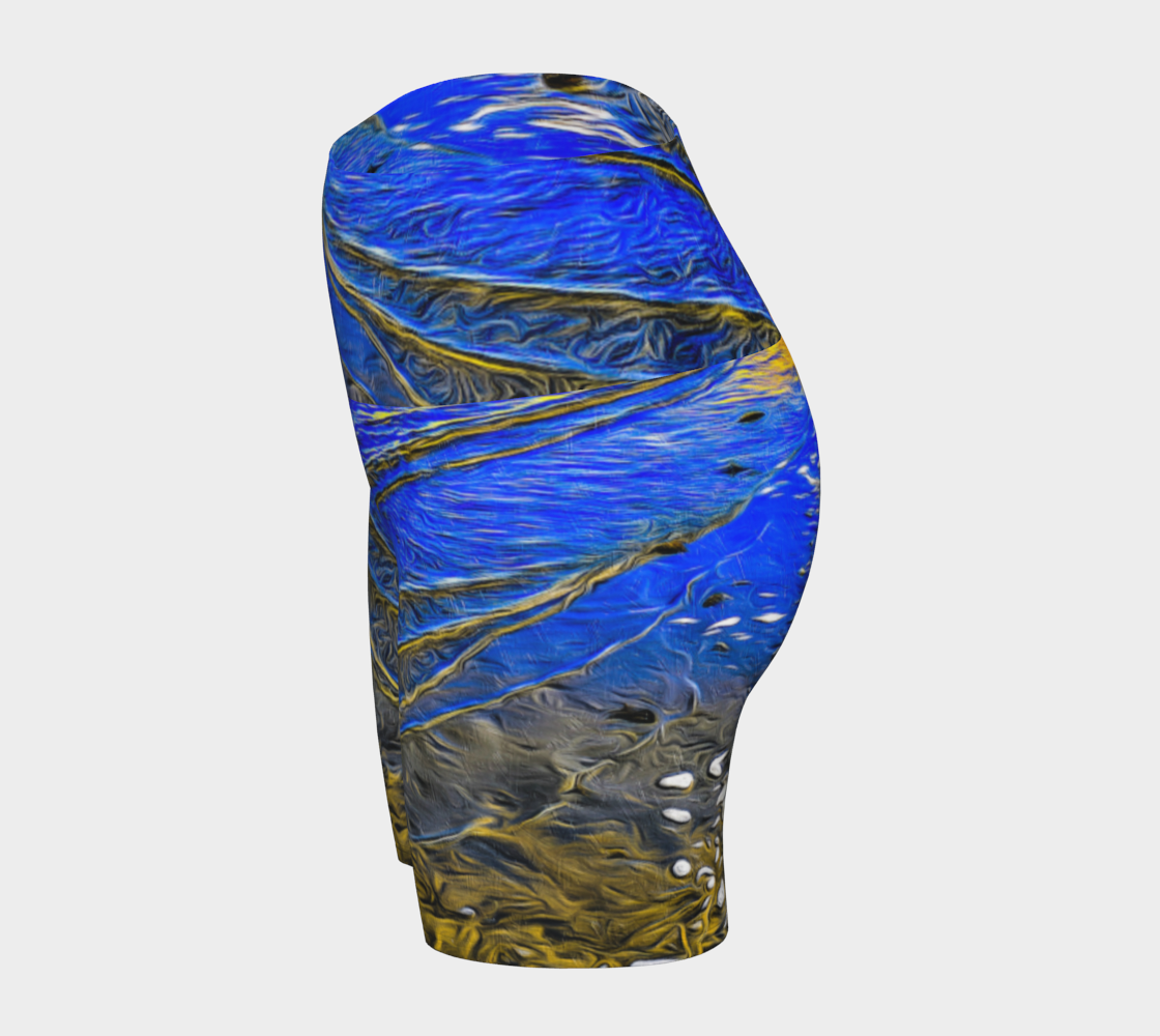 Ebb and Flow All over print yoga shorts.  The shorts feature a image of the ocean water at low tide on Parksville Beach.  the blue sky and the sun is reflecting on the water as the waves gently ripple across the sand.  A painterly effect was added to create a artistic effect.