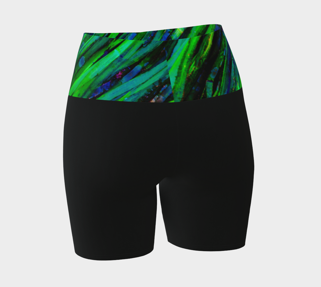 Shades of green yoga shorts features the image of spring green ocean sea grass at low tide. the rest of the shorts are black.