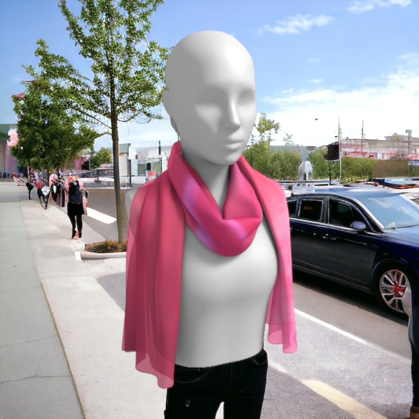 Soft rose long scarf is shown worn around the neck.