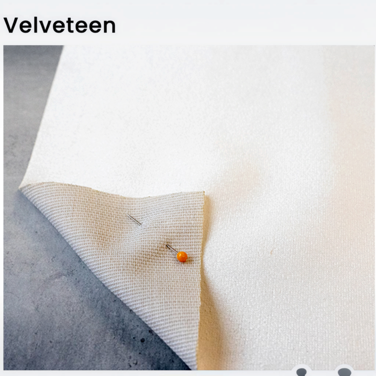 Van Isle Goddess velveteen fabric swatch showing a soft white surface texture with a pinned corner detail