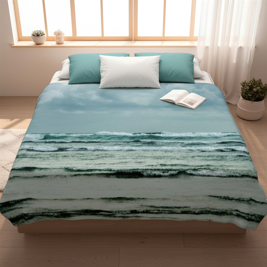 Van Isle Goddess Ocean Calling Long Beach Tofino Coastal Blanket, featuring waves and clouds. Made of polyester minky fabric.
