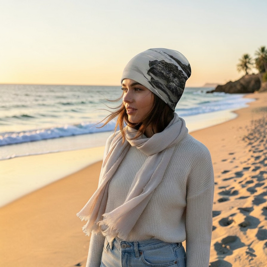 Van Isle Goddess Cox Bay Afternoon Beanie, a slouchy, lightweight beanie with a grey and black rocky beach print, bamboo lining, and spandex blend.