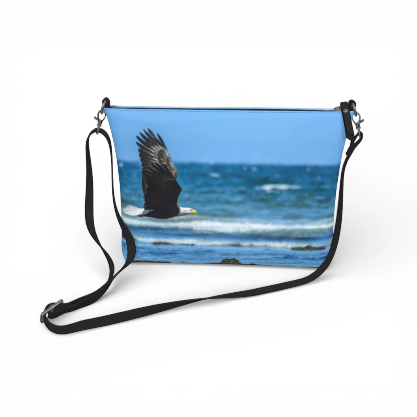 Van Isle Goddess vegan leather crossbody purse with eagle flying over ocean graphic. Adjustable strap.