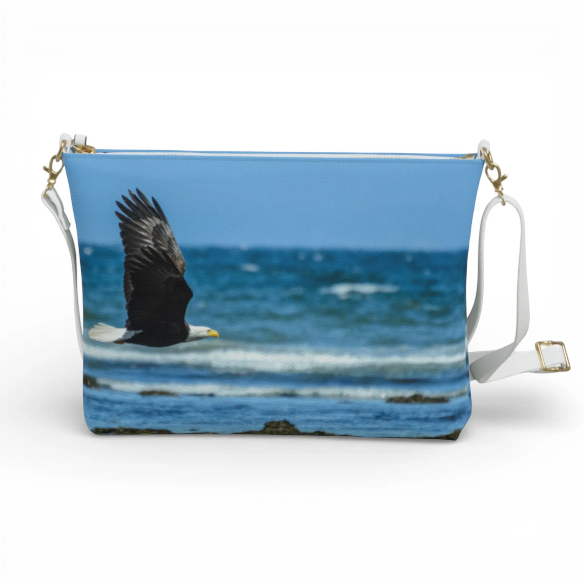 Van Isle Goddess vegan leather crossbody purse with a bald eagle flying over the ocean graphic. Features adjustable strap.
