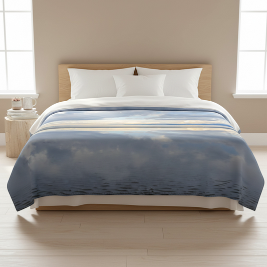 Van Isle Goddess Light Language Parksville Beach coastal blanket, featuring a serene ocean reflection under a cloudy sky. Double minky polyester.