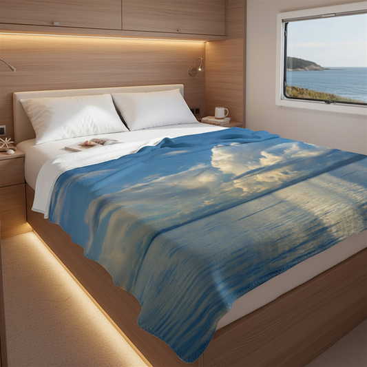 Van Isle Goddess Qualicum Beach coastal blanket with blue sky, clouds, and ocean reflection. Made of polyester minky.