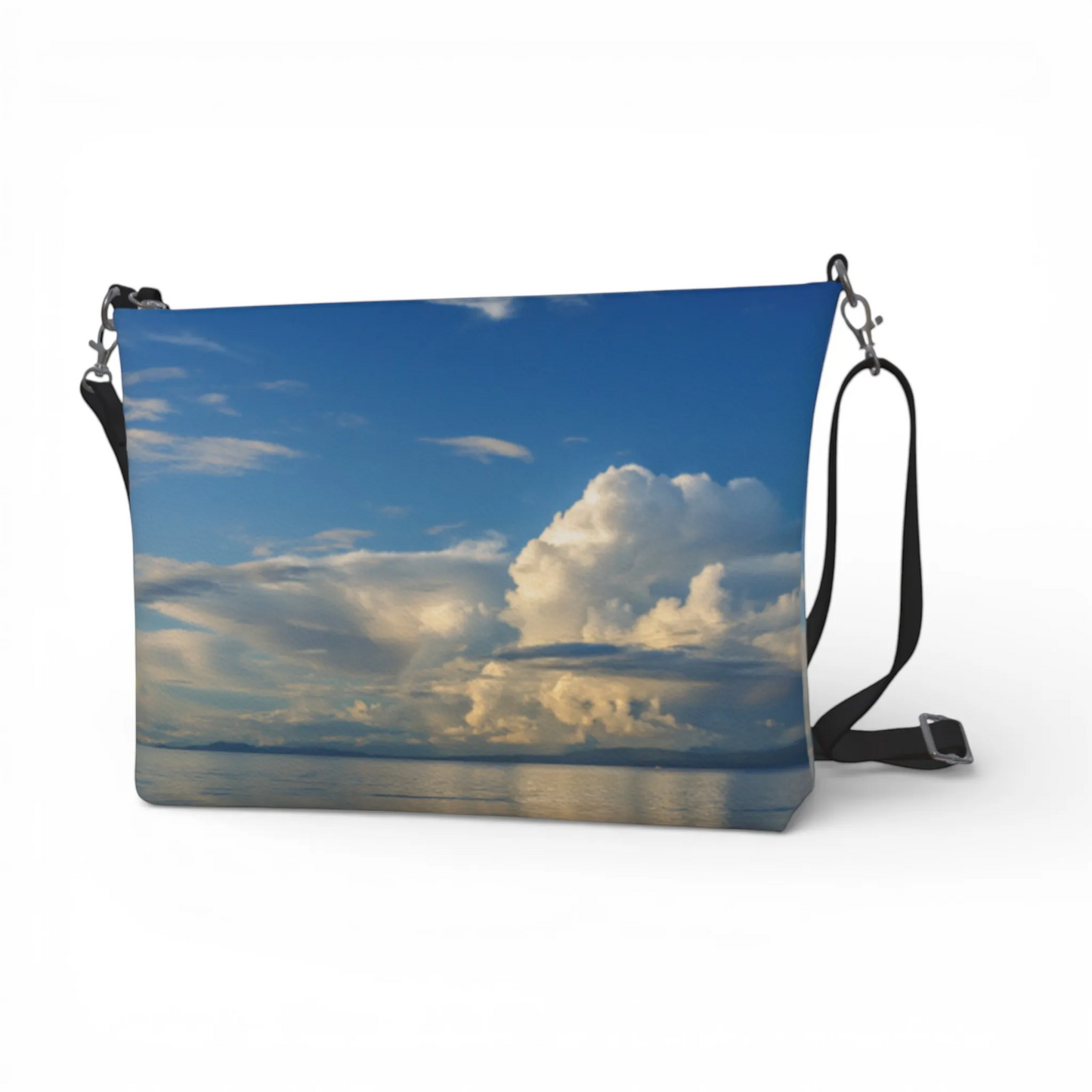 Van Isle Goddess Qualicum Beach crossbody purse with a sky and clouds print on vegan leather, adjustable strap.