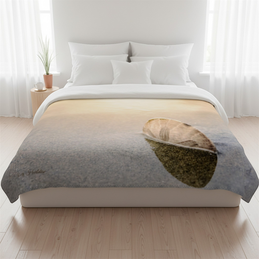Van Isle Goddess sand dollar blanket in soft minky fabric, featuring a sand dollar on a beach at sunset.