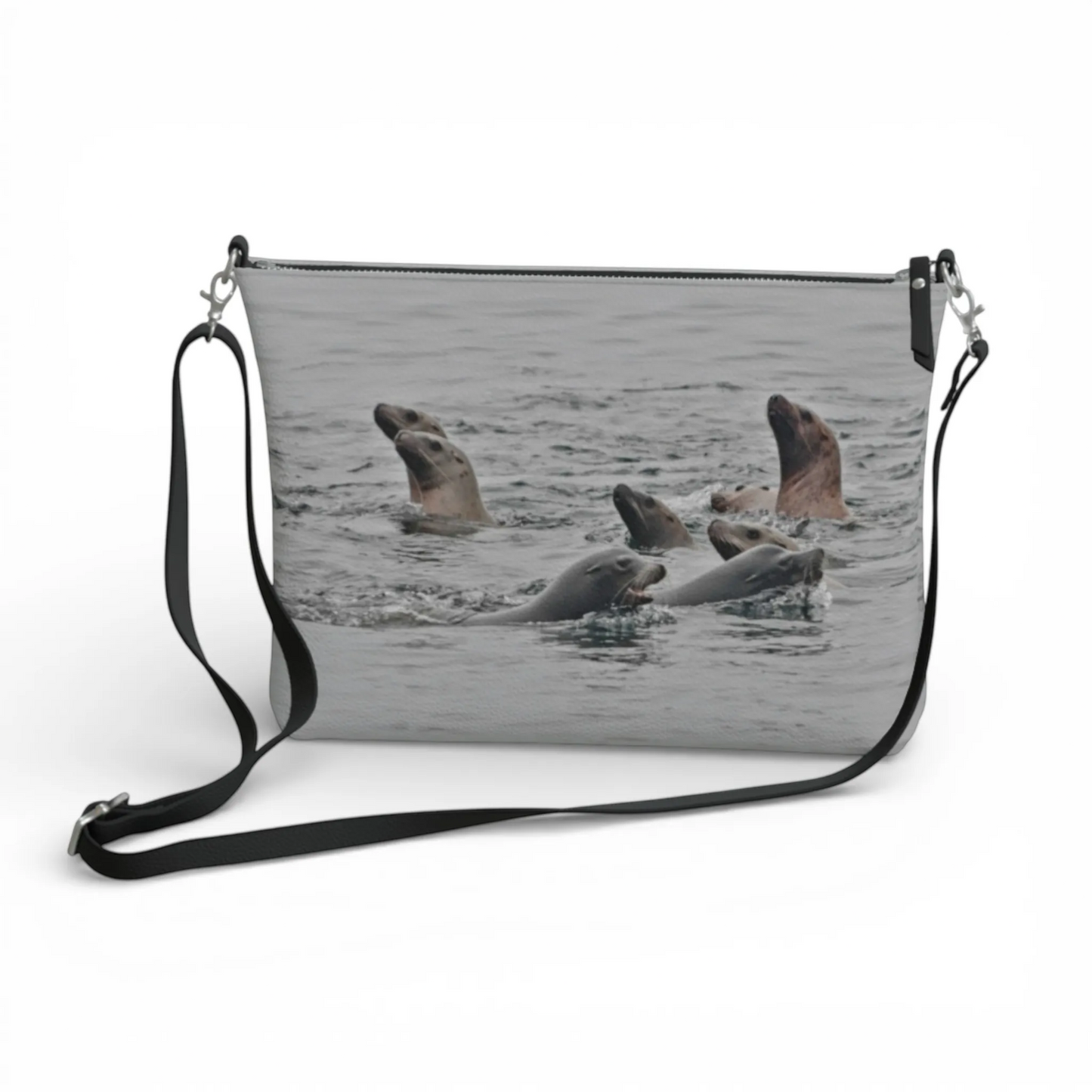 Van Isle Goddess Sea Lions vegan leather crossbody purse with adjustable strap and zipper closure, featuring a print of sea lions swimming.