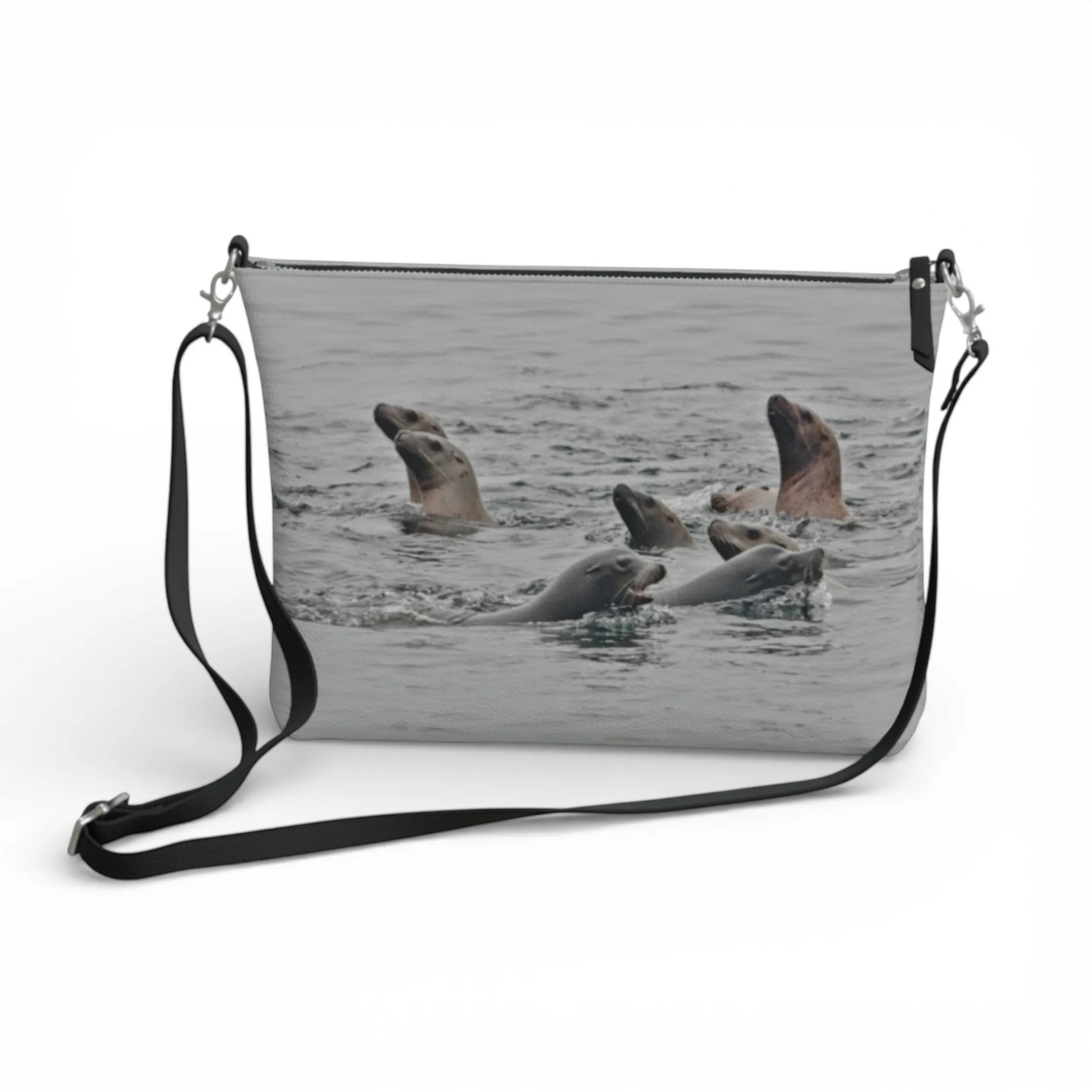 Van Isle Goddess Sea Lions vegan leather crossbody purse with adjustable strap and zipper closure, featuring a print of sea lions swimming.