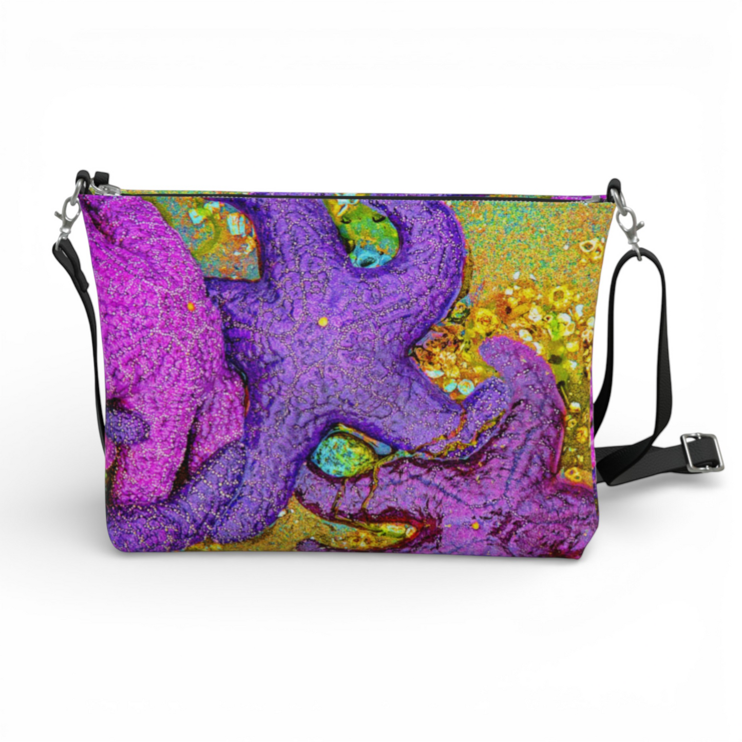 Van Isle Goddess crossbody purse with a vibrant purple and pink starfish cluster print on vegan leather, adjustable strap.