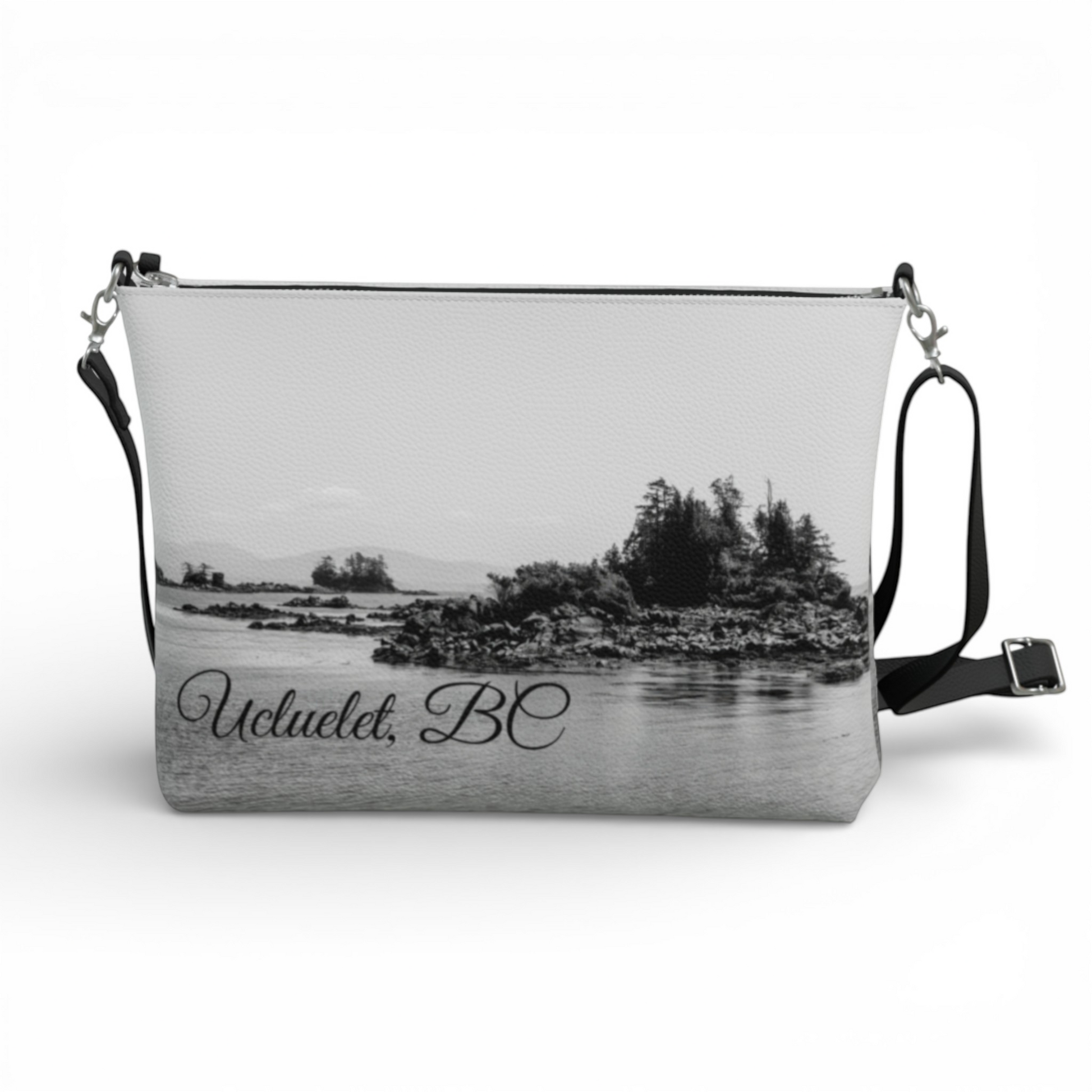 Van Isle Goddess Ucluelet vegan leather crossbody purse with adjustable strap and black trim. Features a scenic black and white landscape print.