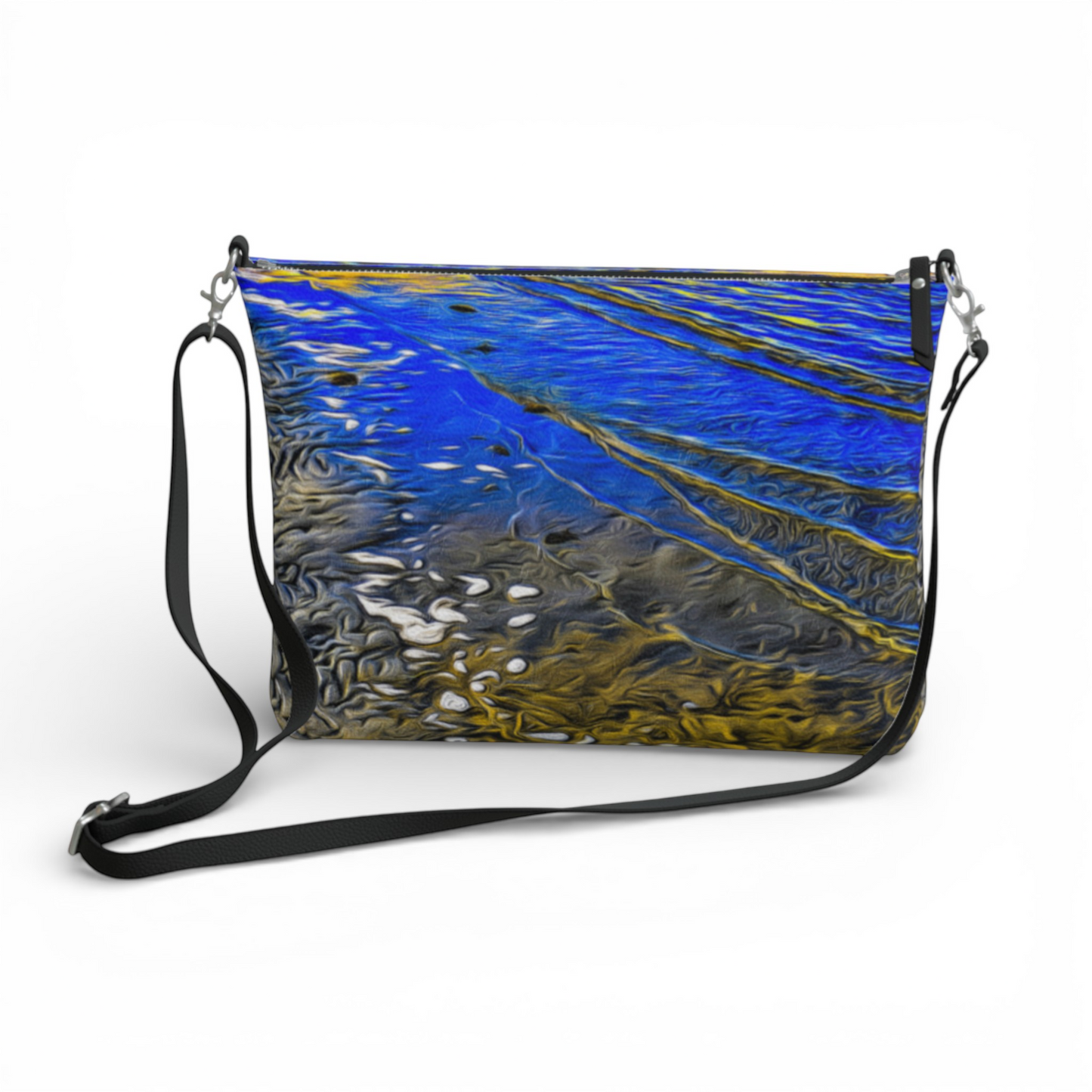 Van Isle Goddess Ebb & Flow crossbody purse in vegan leather with a blue and gold abstract water print, adjustable strap, and metal hardware.