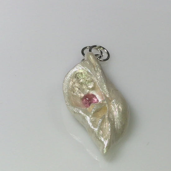 A video This natural seashell pendant has Pink Tourmaline gemstone and three Herkimer Diamonds that compliments the pendant.