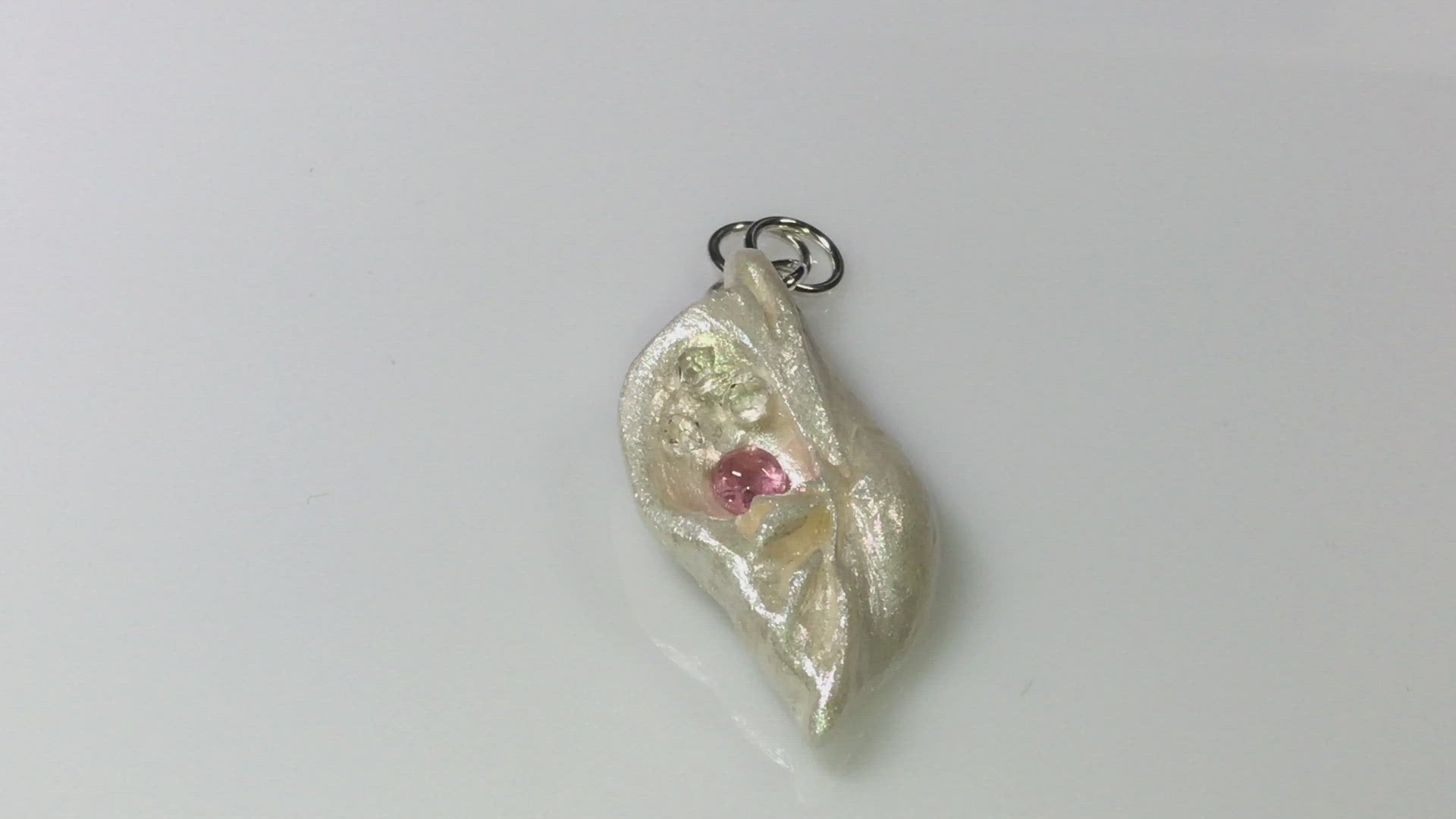 A video This natural seashell pendant has Pink Tourmaline gemstone and three Herkimer Diamonds that compliments the pendant.