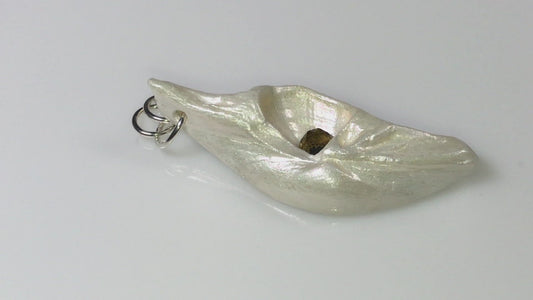 A video showcasing Seer is a natural seashell pendant with a beautiful 5mm rose cut Smokey Quartz compliments the pendant.