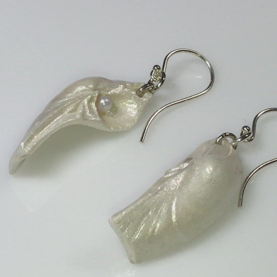A video showcasing Seraphina natural seashell earrings with real baby freshwater pearls. 