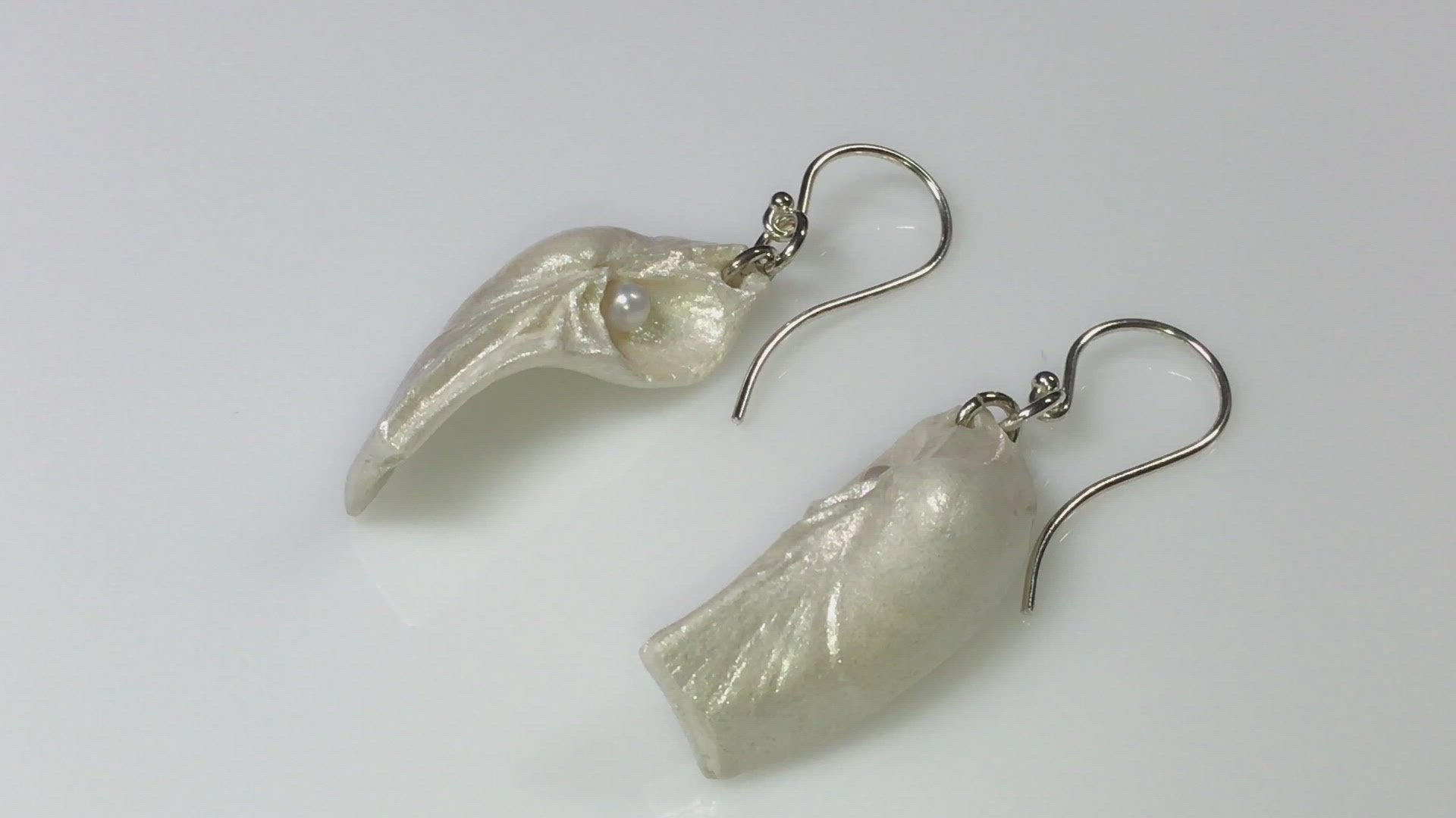 A video showcasing Seraphina natural seashell earrings with real baby freshwater pearls. 